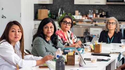 four women sitting at a table